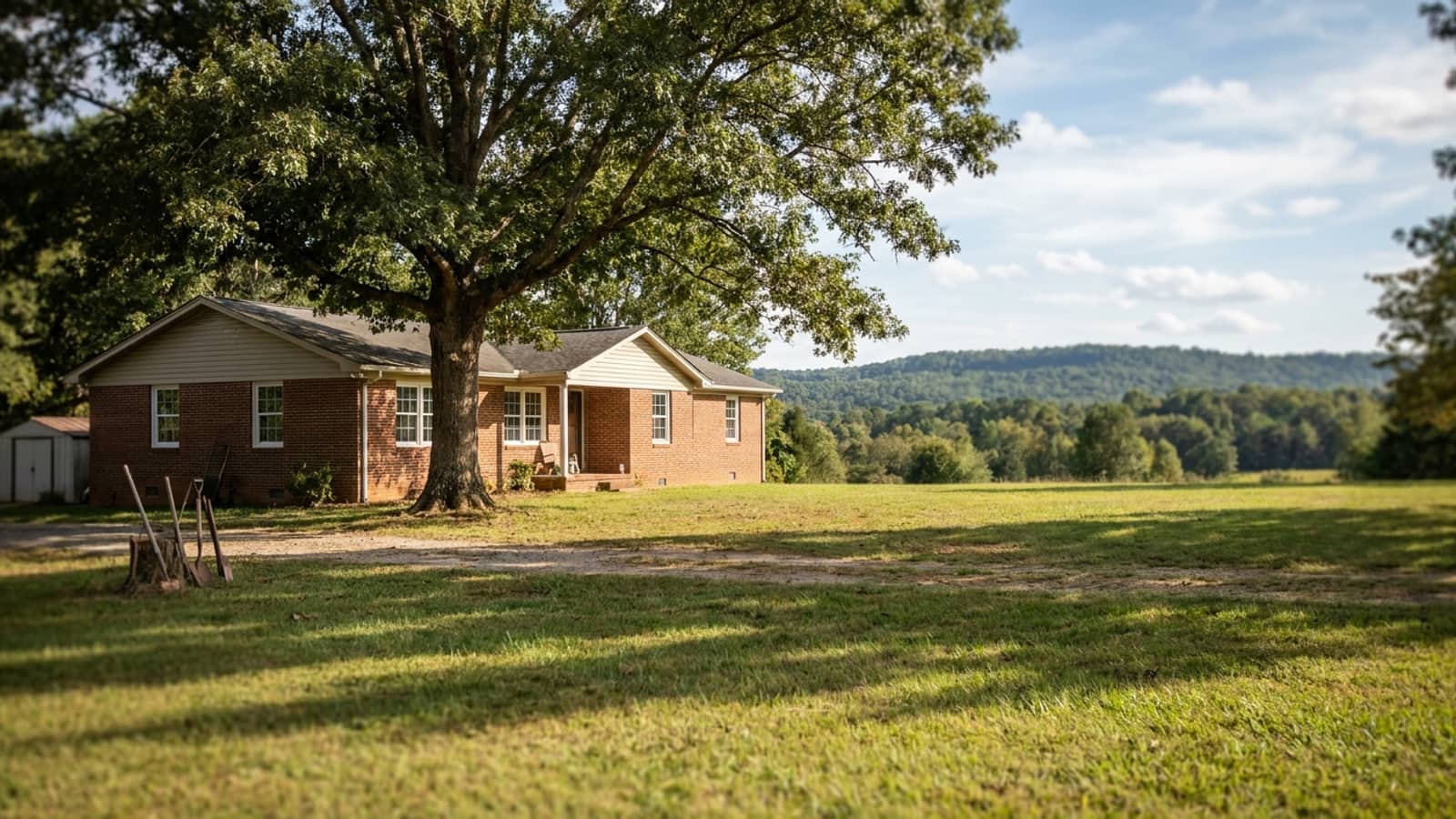 North Georgia ranch home with new white vinyl windows, a brick and siding exterior and a shaded front lawn