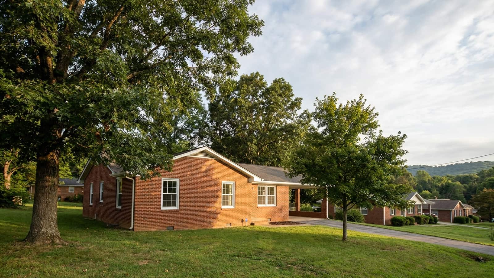 Brick ranch home with new white double-hung windows in a leafy metro Atlanta neighborhood